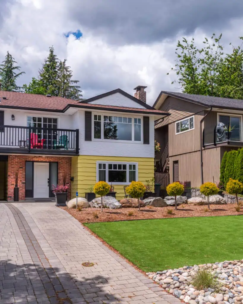 Contemporary house with landscaped garden, driveway, and colorful exterior details.