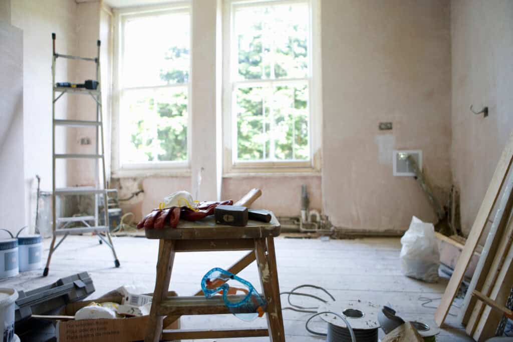 Renovation site showing ongoing interior work with tools and construction materials.